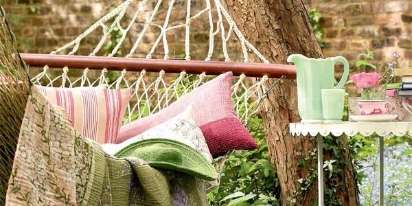 romantic backyard escape hammock pillows small table