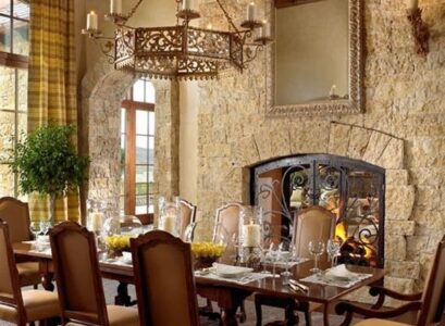 rustic-dining-room-Tuscan-decor-stone-wall-fireplace-solid-wood-furniture-wrought-iron-chandelier