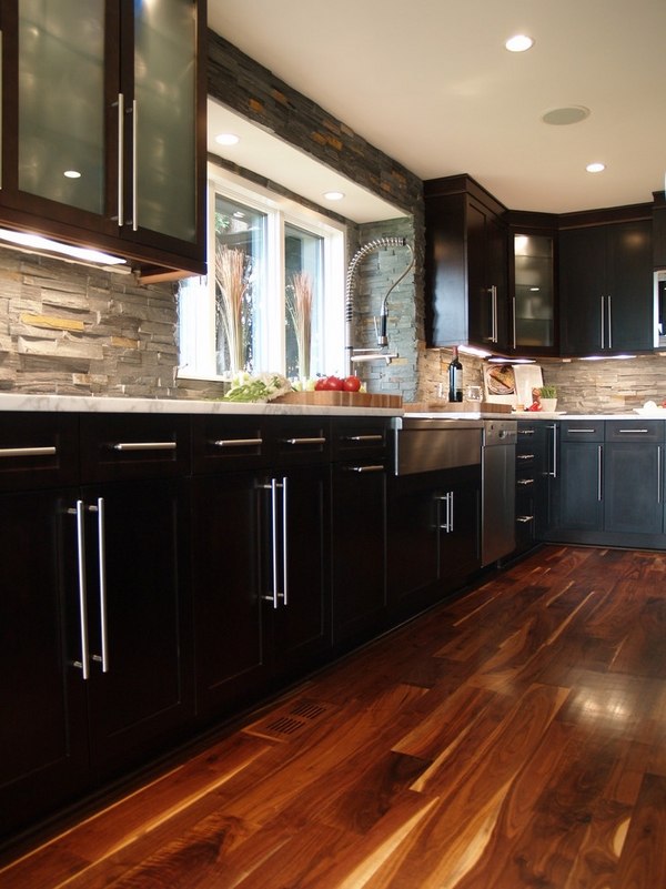 modern kitchen black cabinets wood flooring stone