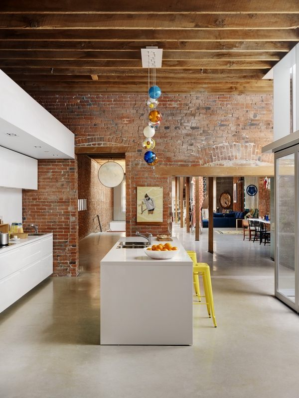 contemporary kitchen industrial decor white kitchen cabinets brick wall exposed wooden beams