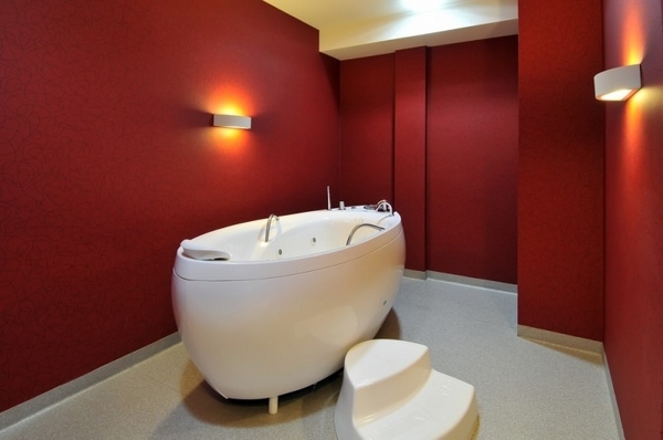 contemporary red bathroom with hydro massage bathtub oval shape