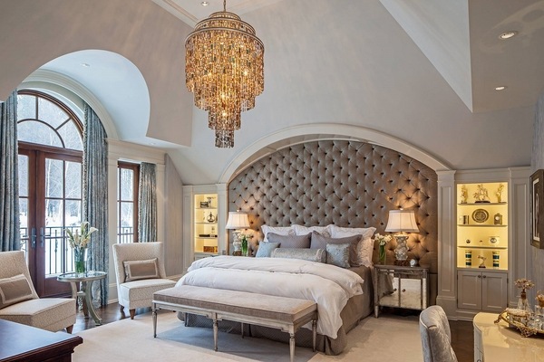 elegant bedroom design arched window large chandeliers tufted headboard 