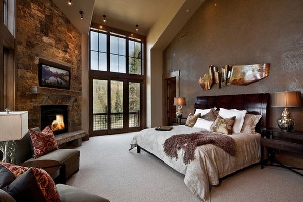 modern bedroom rustic decor upholstered headboard stone fireplace stylish ceiling light