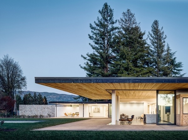 modern house exterior cedar stone concrete deck lawn glass sliding doors