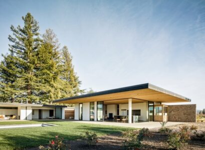 modern-house-exterior-cedar-wood-natural-stone-flat-roof-sliding-glass-doors-court-yard