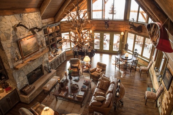 rustic living room fantastic natural stone fireplace wood mantel shelves antler chandelier