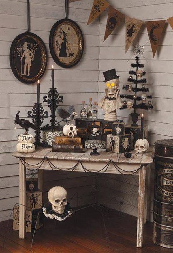 vintage-halloween-decorations-wall pictures wooden table black chandeliers skulls