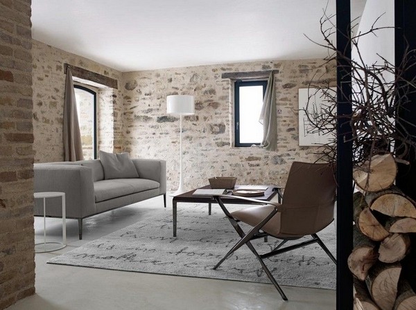 Light gray modern sofa country style living room stone walls carpet