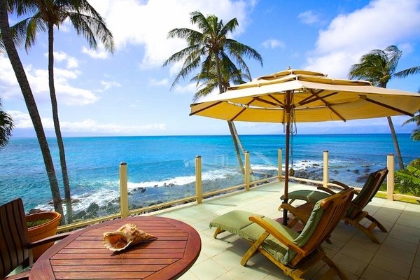 tropical outdoor umbrella sun loungers wooden table
