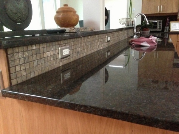 Coffee-brown-granite-countertop-wood-cabinets-mosaic-tile-backsplash