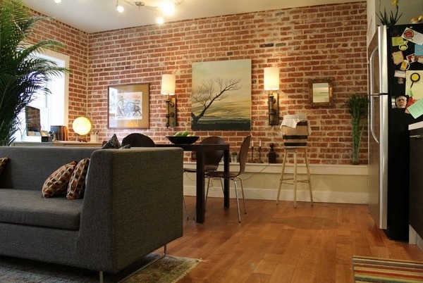 exposed-brick-wall-in-living-rooms-loft-style-design-ideas-wood-flooring gray sofa