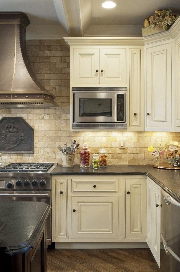 mediterranean kitchen design travertine backsplash white cabinets 