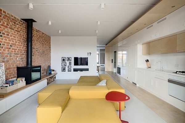 modern-open-plan-living-room industrial style design-brick-wall-white kitchen cabinets yellow sofa