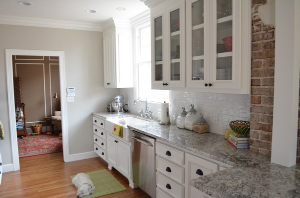 small rustic granite white wooden cabinets exposed brick wall