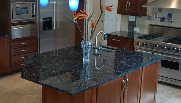 blue-granite-countertop-dark-wood-kitchen-cabinets-kitchen-island