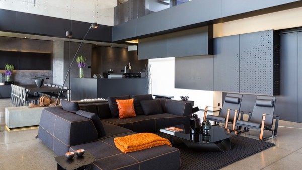 contemporary living room polished concrete flooring black sofa orange accents