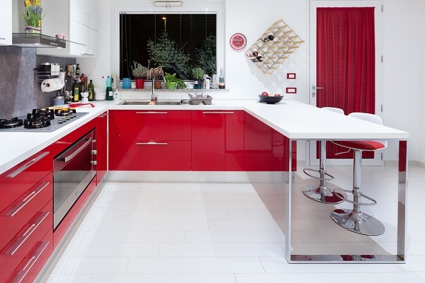 modern kitchen U shaped red cabinets white countertops