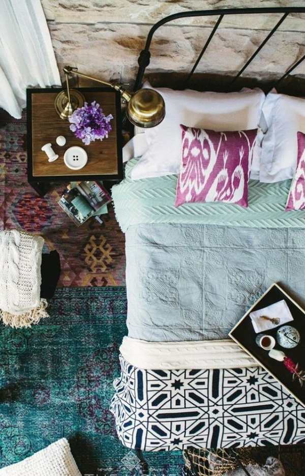 Bohemian chic bedroom design ethnic carpet iron bed frame purple pillows