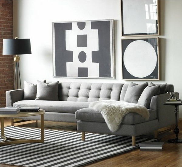 Gray living room sofa black striped carpet wall art
