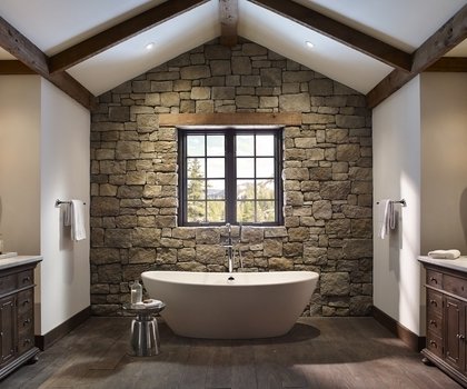 Rustic-bathroom-decor-stone-walls-freestanding-tub-exposed-ceiling-beams