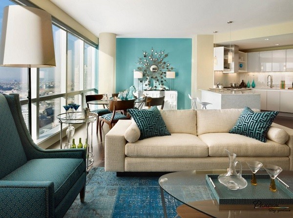 contemporary open plan living room teal accent wall white sofa teal armchair 