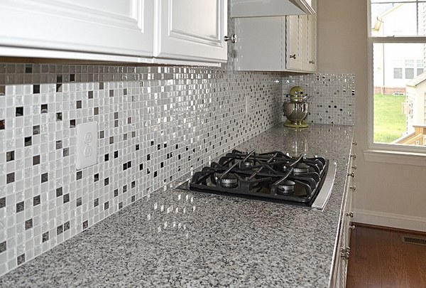 luna pearl granite countertop glass tile kitchen backsplash white cabinets