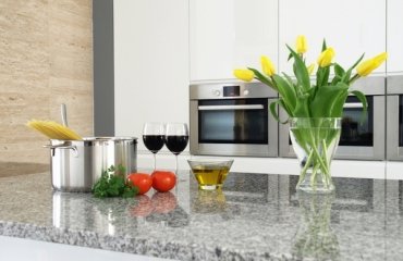 modern-granite-countertops-luna-pearl-granite-countertop-white-kitchen-cabinets