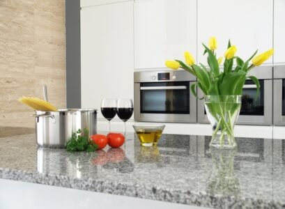modern-granite-countertops-luna-pearl-granite-countertop-white-kitchen-cabinets