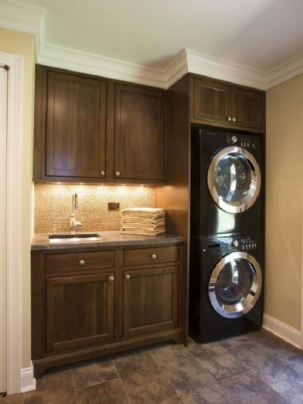 small-laundry-room-ideas-dark-wood-cabinets-under-cabinet-lighting-stacked-washer-dryer