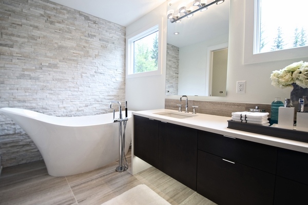 modern bathroom floating vanity freestanding tub ledgestone tile wall
