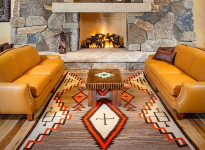 living-room-rug-ideas-navajo-rug-stone-fireplace-leather-sofa-set