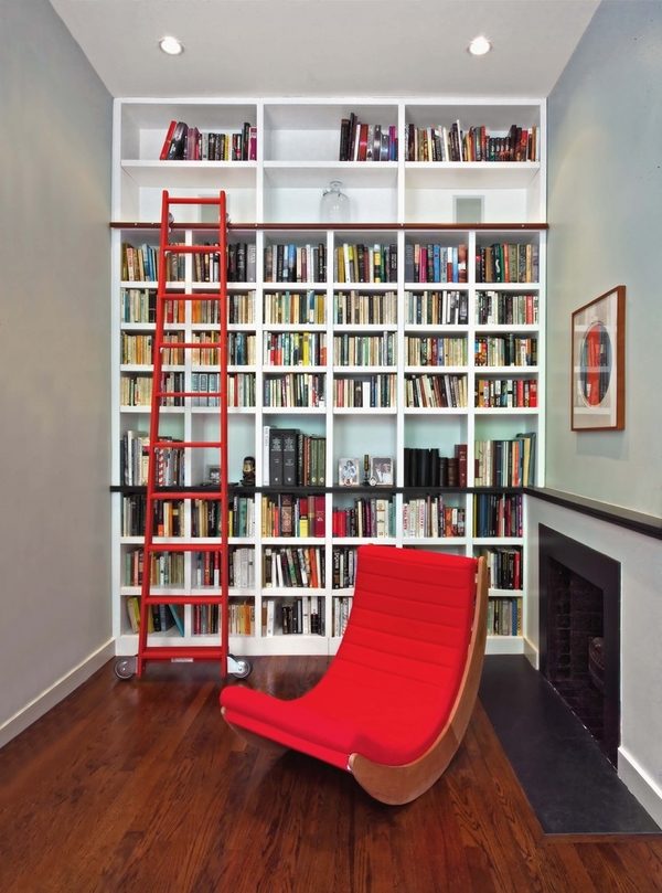 small home library floor to ceiling bookshelves red rolling ladder cool armchair