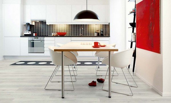 grey hardwood floors modern dining area red wall accent white dining chairs