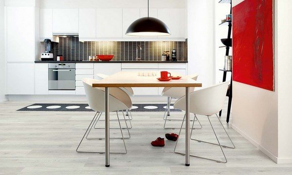 grey-hardwood-floors-modern-dining-area-red-wall-accent-white-dining-chairs