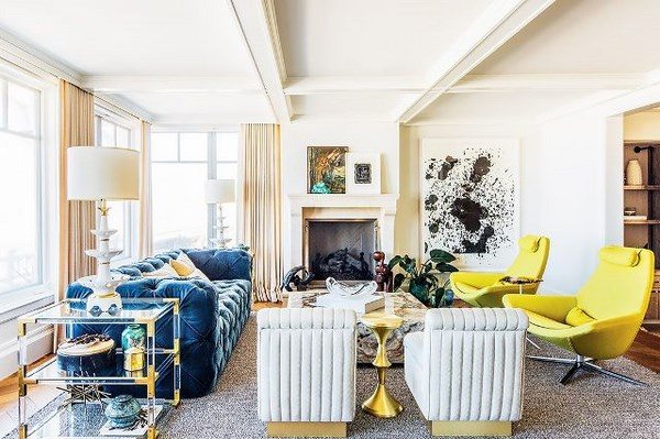 chartreuse armchairs and blue sofa in living room