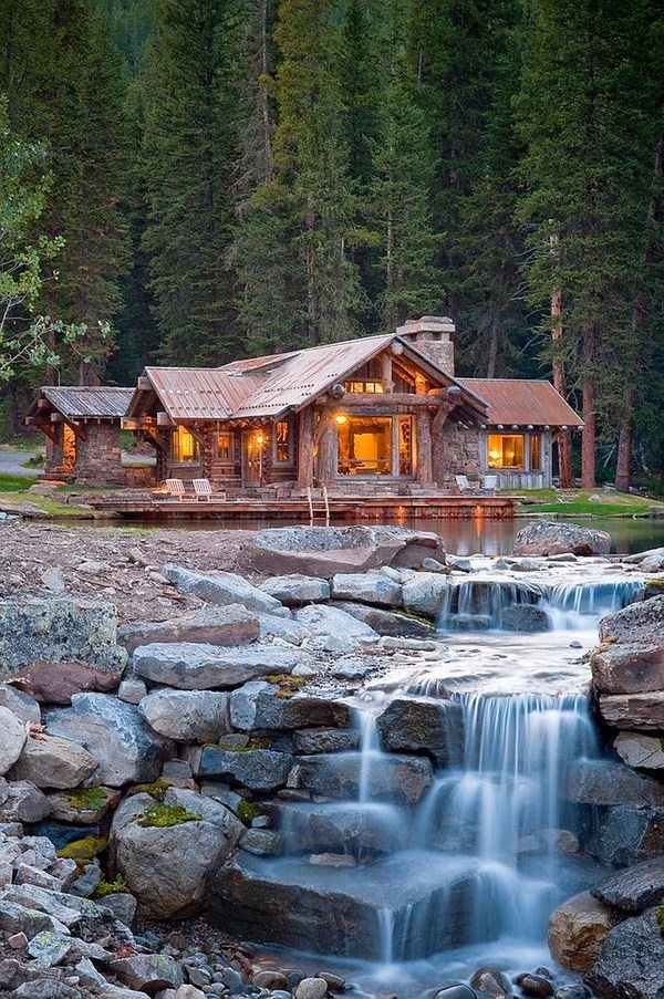log cabin retreat exterior design water feature waterfall
