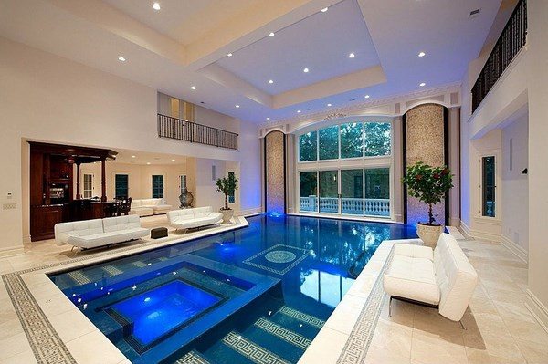 luxury indoor pool with bar area and white furniture