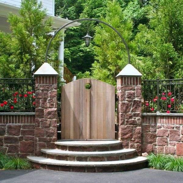 wooden gate stone post metal arch garden fence
