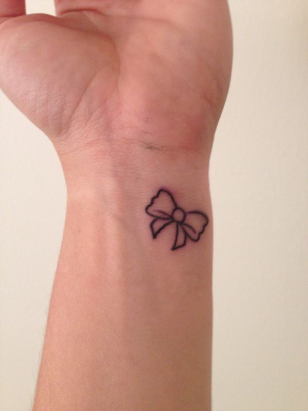 tiny bow tattooo on wrist