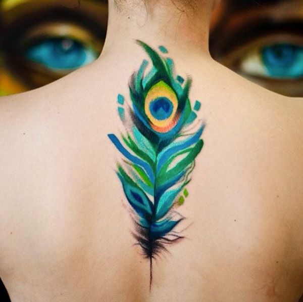 watercolor peacock tattoo on spine