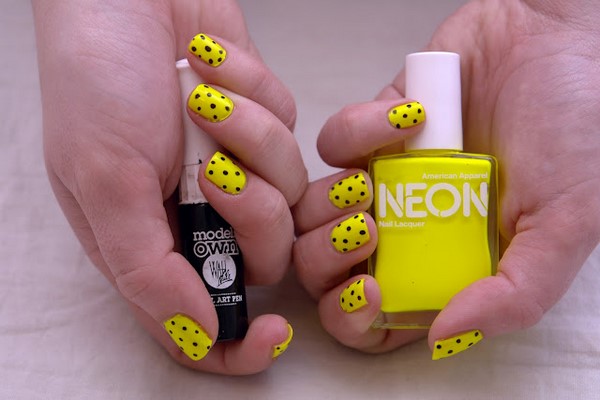 Neon yellow nails with black polka dots