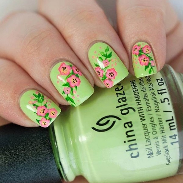 green nail color with floral decoration
