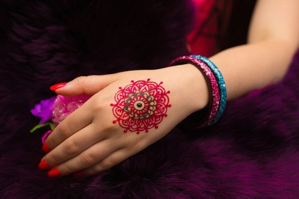 colorful mandala tattoo on hand
