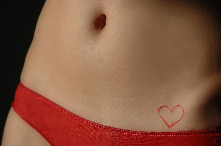 small red heart tatoo on hip