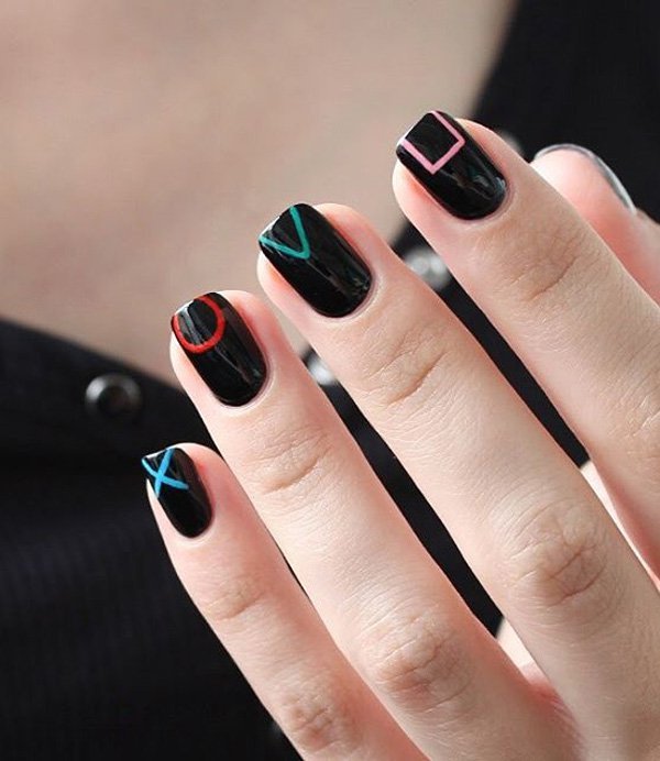Black nail art with colorful geometric patterns