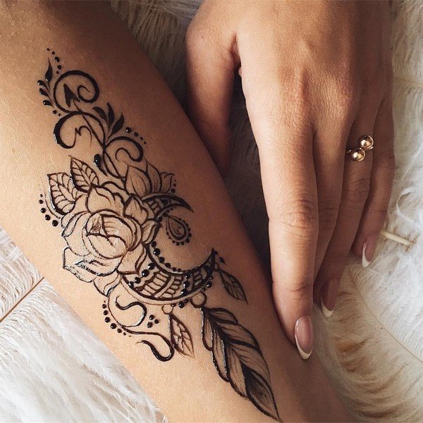 henna tattoo on arm flower feather