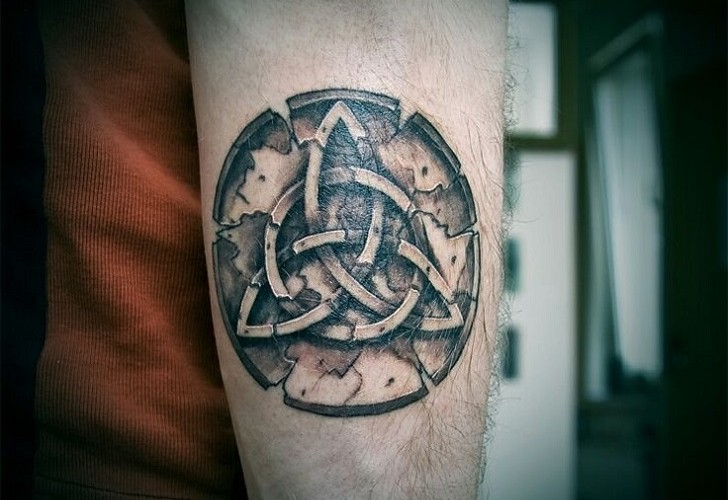 Triquetra tattoo located on the inner arm, fine line