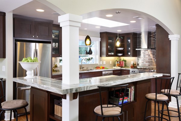 L shaped kitchen and breakfast bar dark cabinets granite countertops