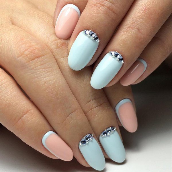 beautiful manicure in pastel blue with rhinestones