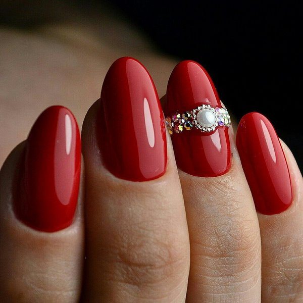 classic red manicure with rhinestone decoration